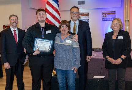 Tommy Roberts, second from left, is presented the Gold Star Mission scholarship in memory of Illinois Army National Guard Spc. Charles Lamb, of Casey, Illinois, during the 9th annual Gold Star Mission scholarship banquet in Springfield March 21.