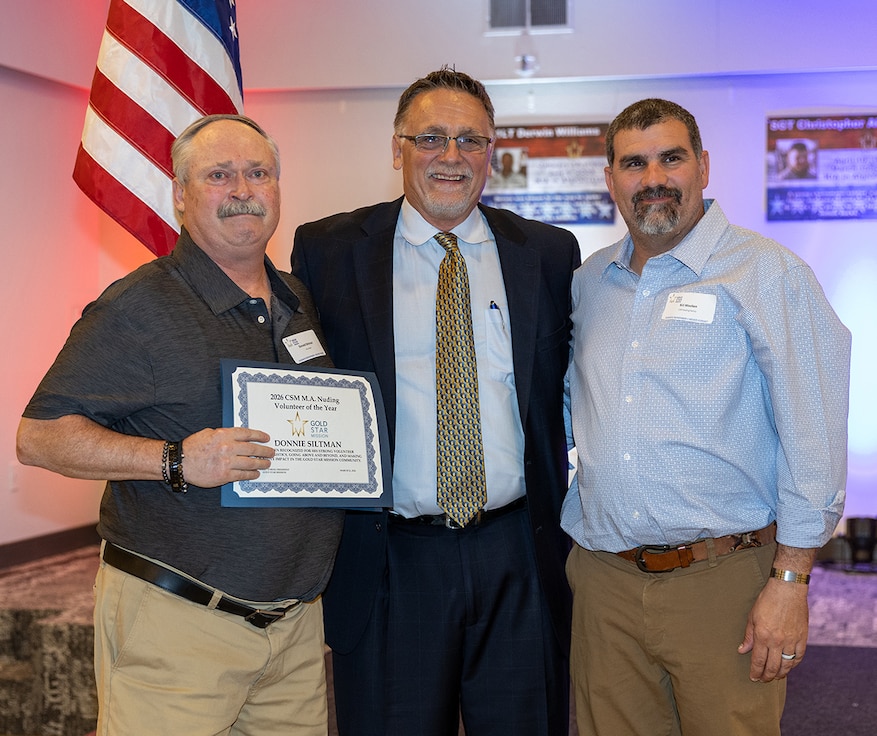 Donald Siltman, left, is presented the Command Sgt. Maj. Michael A. Nuding award during the Gold Star Mission scholarship banquet in Springfield March 21.