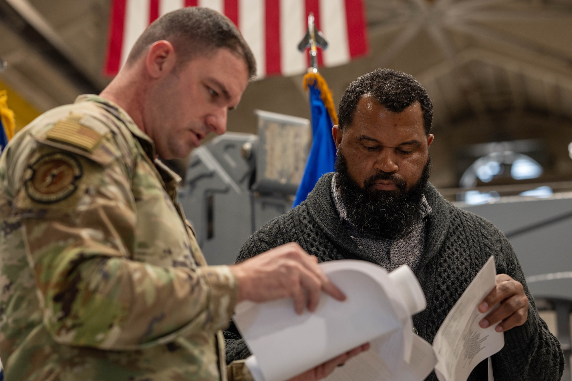 U.S. Air Force Master Sgt. Cody Skipper, 325th Force Support Squadron readiness noncommissioned officer , and Marshall Dixon, 325th Fighter Wing protocol specialist, review a script during a ceremony rehearsal at Tyndall Air Force Base, Florida, Feb. 5, 2026.