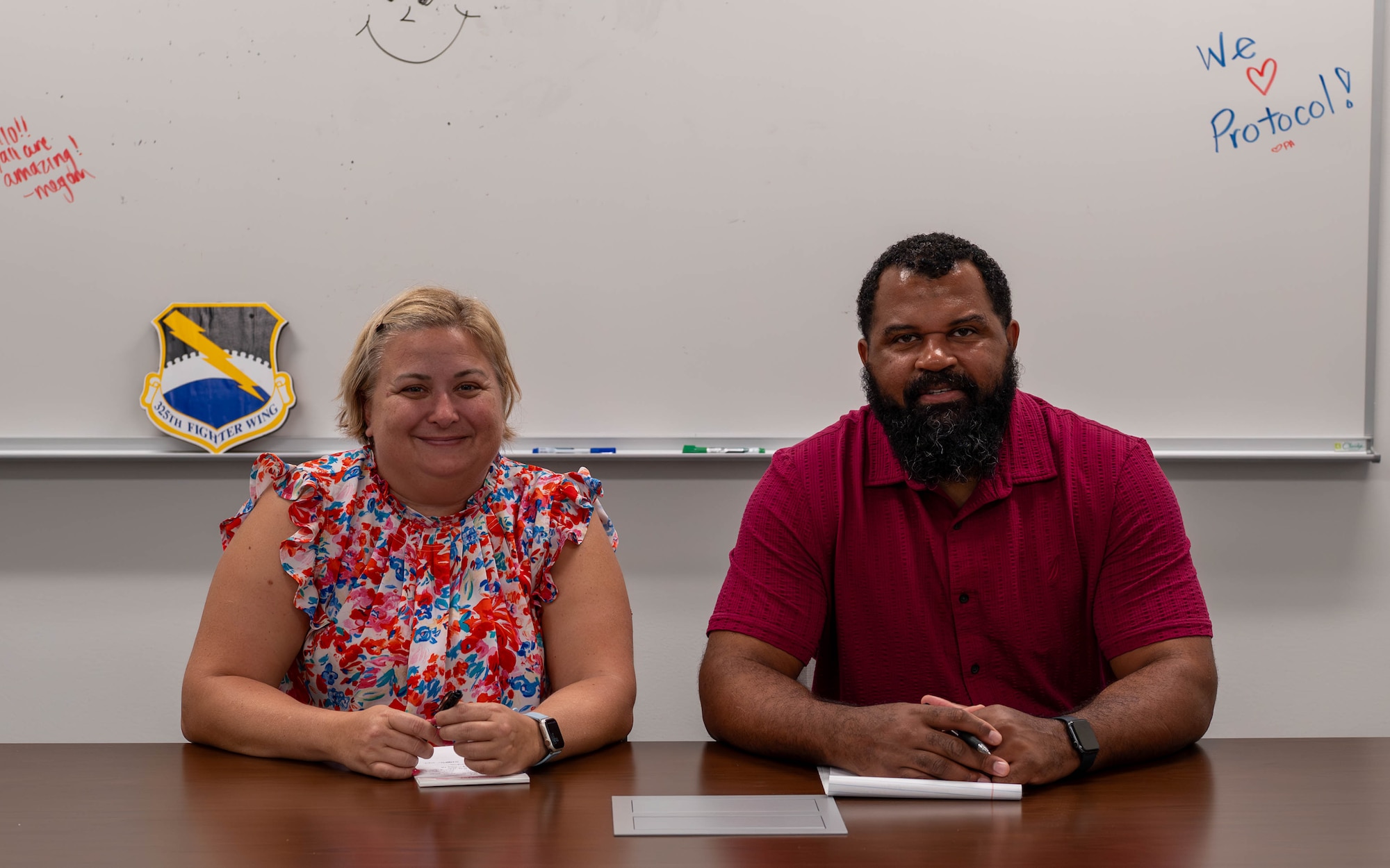 Christi Skiles, 325th Fighter Wing chief of protocol, and Marshall Dixon, 325th FW protocol specialist, pose for a photo at Tyndall Air Force Base, Florida, Feb.  27, 2026.