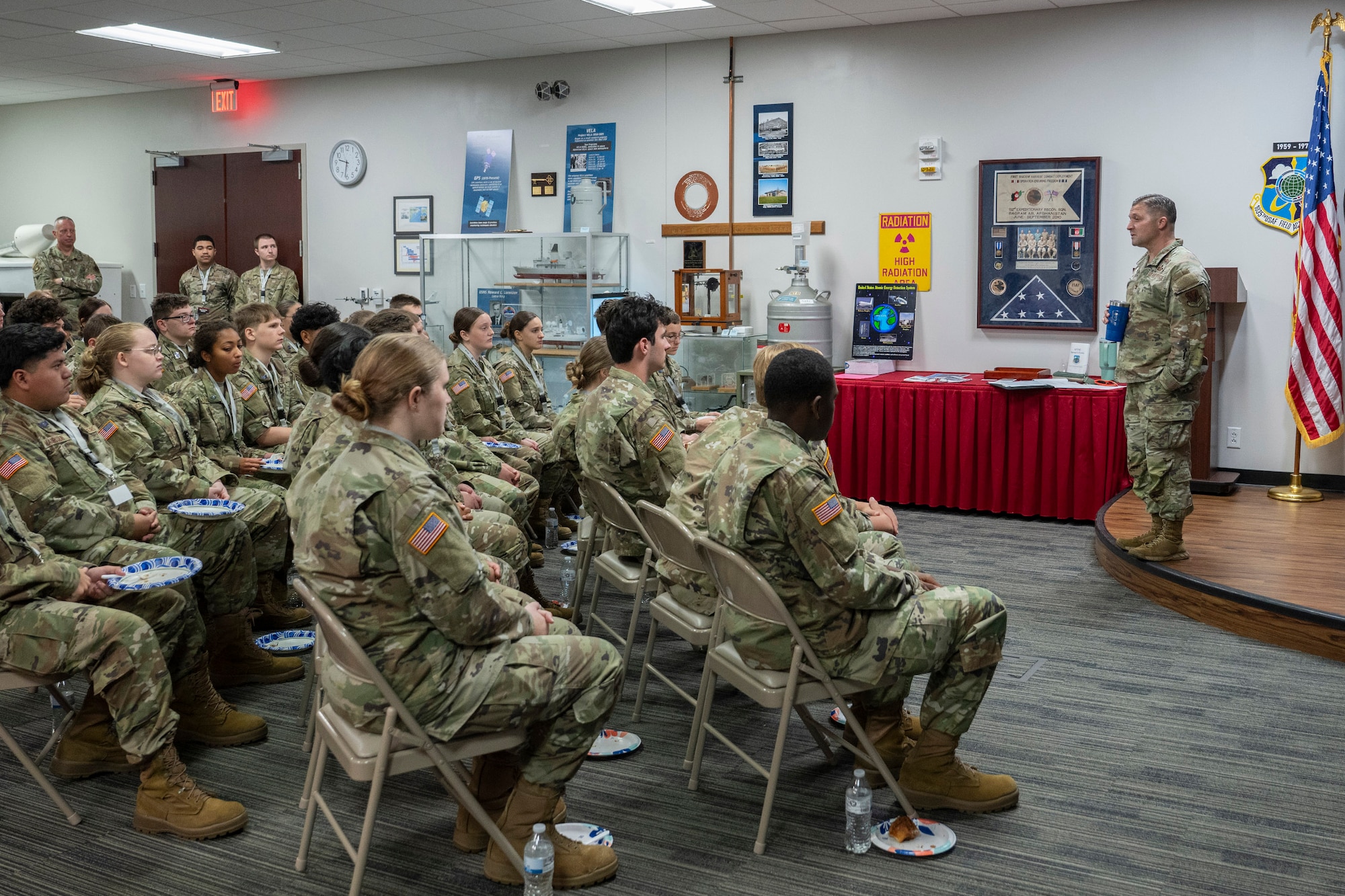 Col. Creighton Mullins (right), commander of the Air Force Technical Applications Center, Patrick Space Force Base, Fla., addresses a group of 36 Junior Reserve Officer Training Corps cadets from Vero Beach High School, Fla., during their visit to the nuclear surveillance center March 17, 2026.   The cadets toured the facility, met with Airmen, and learned about possible career opportunities in the Air Force. (U.S. Air Force photo by Matthew S. Jurgens)