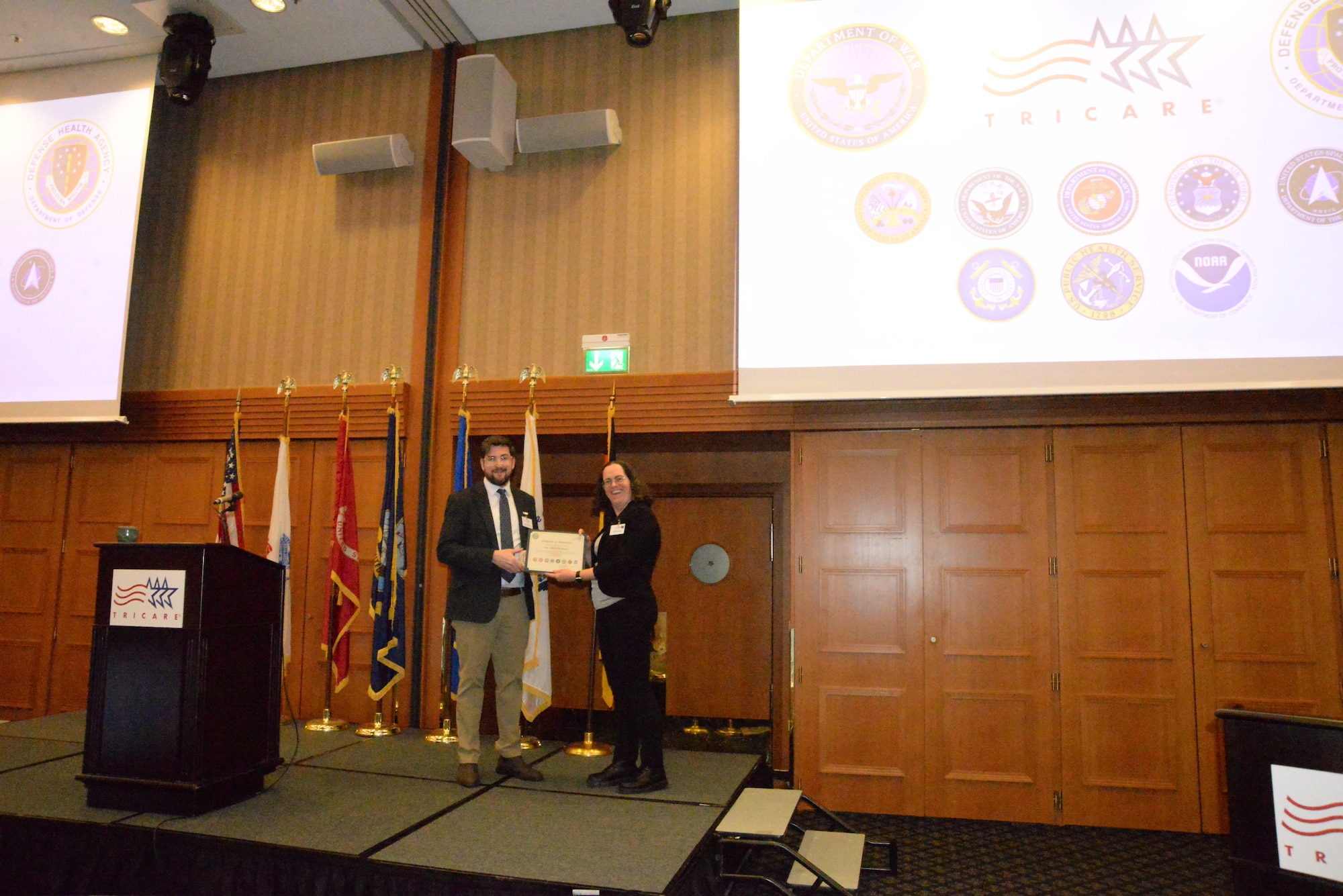 Col. Cristina L. Franchetti, TRICARE Area Office-Eurasia/Africa executive director, presents a certificate of appreciation to Dr. Bryce Slinger, Assistant Secretary of War for Health Affairs chief of staff
