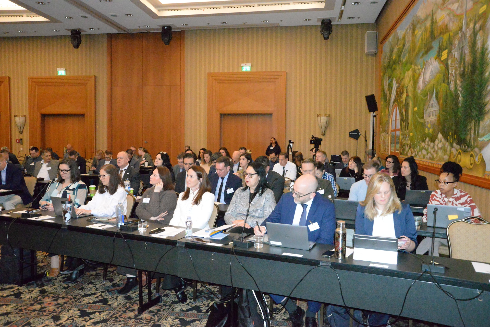 TEAM 2026 members listen to a presentation during a conference.