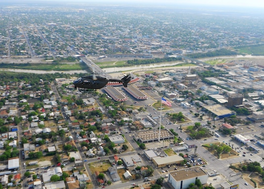LAREDO, Texas, Nov. 19, 2012 - A Georgia Army Guard UH-72A Lakota light-utility helicopter flies over Laredo, Texas, with the Rio Grande River and International Bridge connecting the U.S. to Mexico in the background. Georgia Guardsmen are providing situational awareness to U.S. Customs and Border Protection agents on the ground while they apprehend illegal immigrants who cross into Texas from Mexico at night.