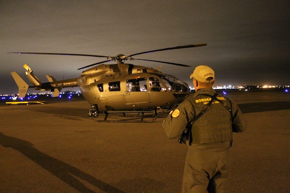 A Rio Grande Valley Border Patrol Agent stands in front of a Georgia Army National Guard LUH-72 Lakota before they take off on an aerial detection and monitoring  mission as part of Operation River Watch II on the U.S. border with Mexico in Texas. The Georgia National Guard volunteered to deploy to the Rio Grande Valley in Texas for all of 2014 to support the Border Patrol in their mission to prevent the entry of terrorists, weapons of mass destruction, illegal contraband, and to disrupt illegal aliens from crossing the river into the United States. (Georgia Army National Guard photo by Maj. Will Cox/Released)