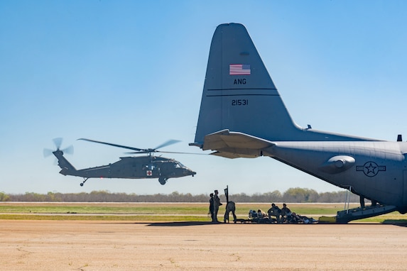A U.S. Army HH-60M Blackhawk helicopter assigned to the Georgia National Guard's Charlie Company 1-111th General Support Aviation Battalion takes off following a tail-to-tail transfer of simulated casualties with a Lockheed C-130 Hercules aircraft assigned to the Wyoming Air National Guard's 153rd Airlift Wing in Perry, Georgia, March 25, 2025. The mission supports continuity of care objectives by validating rotary-to-fixed-wing interoperability in a joint medical evacuation environment. Approximately 700 participants from the National Guard and federal, state, and local agencies are participating in Patriot 25, a National Guard-sponsored exercise designed to enhance domestic response readiness and interagency coordination. (U.S. Air National Guard photo by Master Sgt. Megan Floyd)