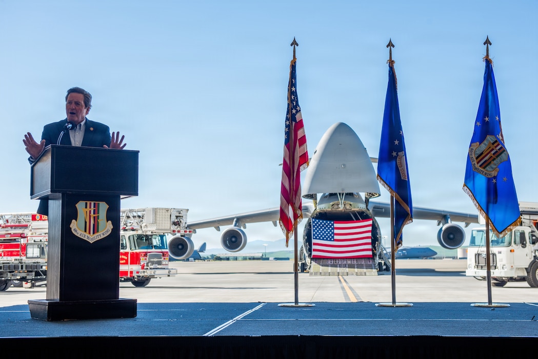 Congressman delivers remarks on stage.