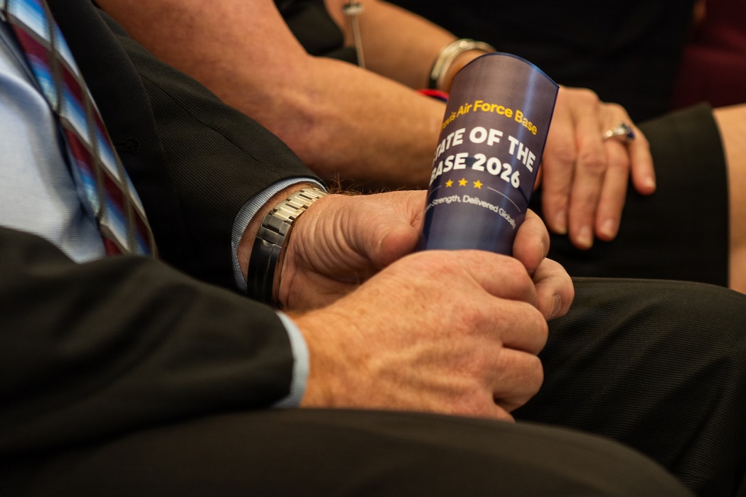 Close up of a community leader holding the pamphlet for the ceremony