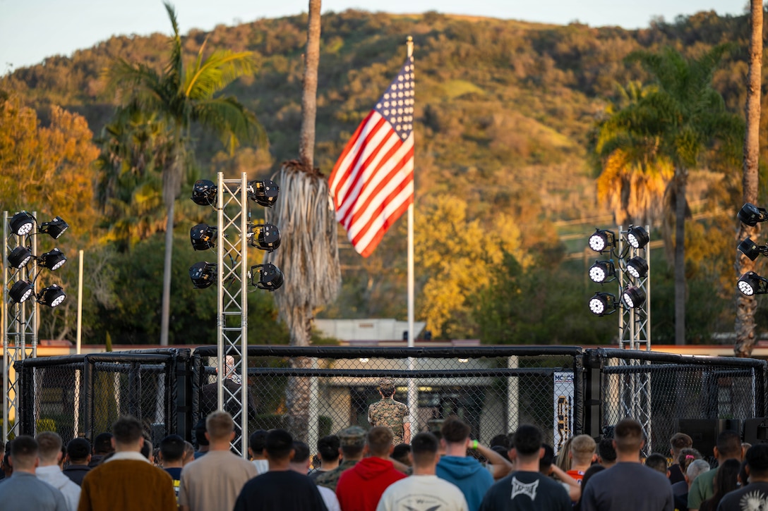 U.S. Marines and Sailors, stand at attention for the national anthem during the MMA Fight Night at Marine Corps Base Camp Pendleton, Calif., March 20, 2026. The event was coordinated by Marine Corps Community Services to promote base cohesion, increase morale and provide entertainment. (U.S. Marine Corps photo by Lance Cpl. Estada)