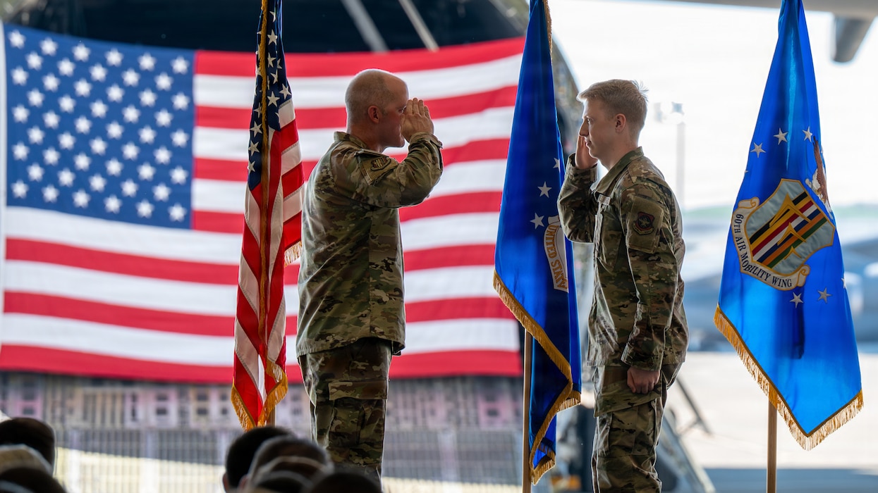 Wing commander shares salute with Airman on stage