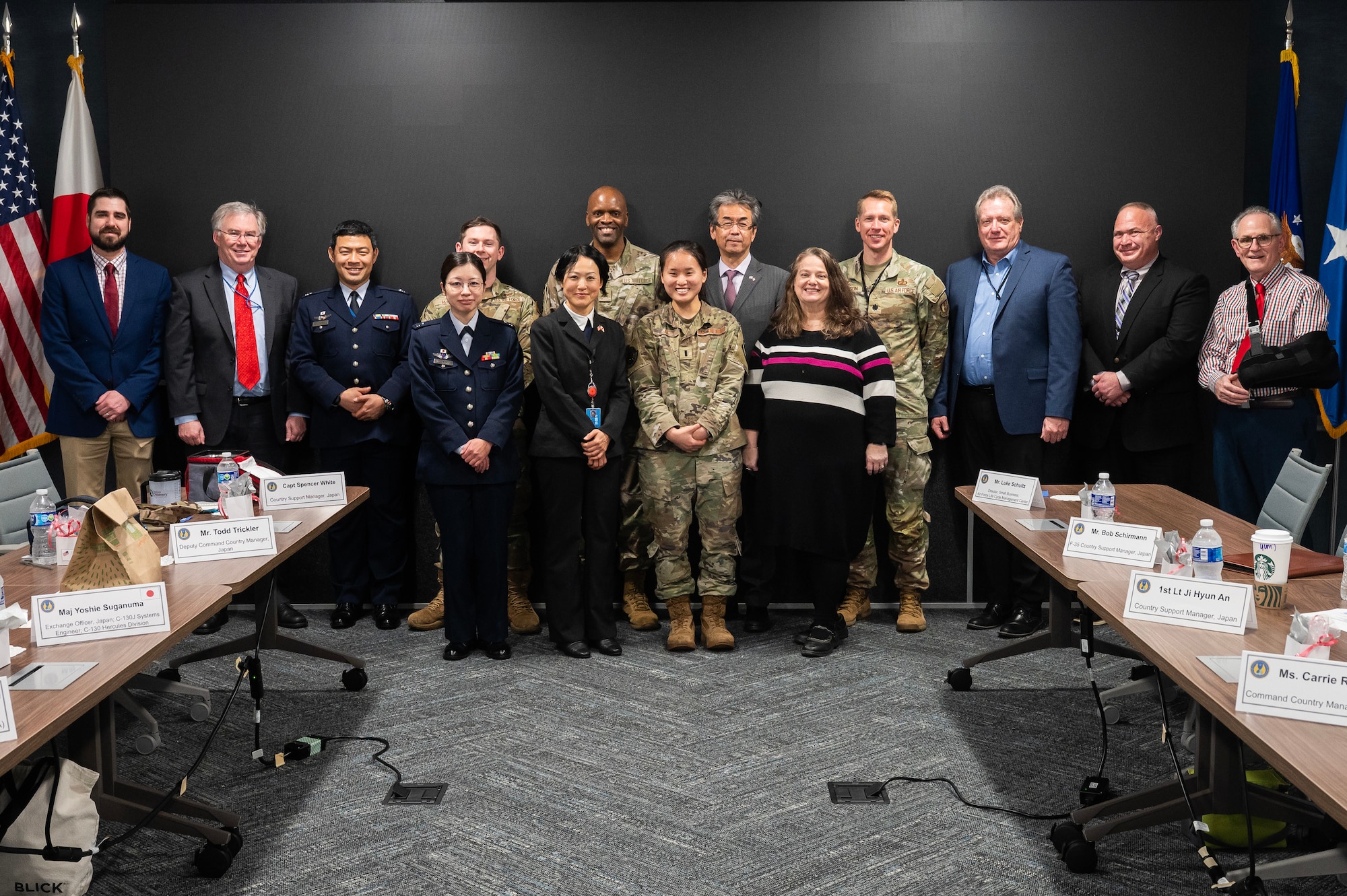 Large group of civilians and Air Force employees pose for group photo.