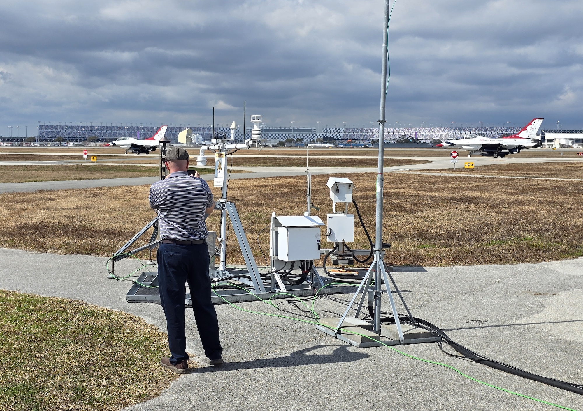 Michael Kaul, Deputy Program Manager for Systems Development Directorate at the Air Force Technical Applications Center, Patrick Space Force Base, Fla., records two U.S. Air Force Thunderbird F-16s as they taxi and prepare for takeoff at Daytona Beach International Airport Feb. 15, 2026.  The Thunderbirds were performing at the 2026 Daytona 500 NASCAR Cup Series, and Kaul and his team deployed the U.S. Prompt Diagnostics System’s new mobile capability to test it in a real-world, high visibility setting in support of National Technical Nuclear Forensics readiness.  (Courtesy photo)