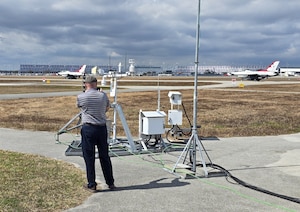 Michael Kaul, Deputy Program Manager for Systems Development Directorate at the Air Force Technical Applications Center, Patrick Space Force Base, Fla., records two U.S. Air Force Thunderbird F-16s as they taxi and prepare for takeoff at Daytona Beach International Airport Feb. 15, 2026.  The Thunderbirds were performing at the 2026 Daytona 500 NASCAR Cup Series, and Kaul and his team deployed the U.S. Prompt Diagnostics System’s new mobile capability to test it in a real-world, high visibility setting in support of National Technical Nuclear Forensics readiness.  (Courtesy photo)
