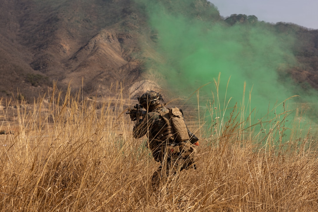 U.S. Marine Corps Lance Cpl. Kaydon Lewellen, a rifleman with 12th Littoral Combat Team, 12th Marine Littoral Regiment, 3rd Marine Division, engages targets with an M27 infantry automatic rifle during a Combined Arms Live-Fire Exercise at Rodriguez Live-Fire Complex, Republic of Korea, Feb. 28, 2026. 12th LCT Marines executed a company-level CALFEX, integrating organic and supporting fires, maneuver elements, and reconnaissance capabilities to conduct a coordinated assault on a designated objective. The range strengthened the unit’s ability to synchronize fires and movement in a dynamic training environment while enhancing combat effectiveness and overall readiness. Lewellen is a native of Montana. (U.S. Marine Corps photo by Lance Cpl. Robert Blanks)