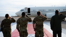 Team Minot leadership salutes an arriving aircraft.