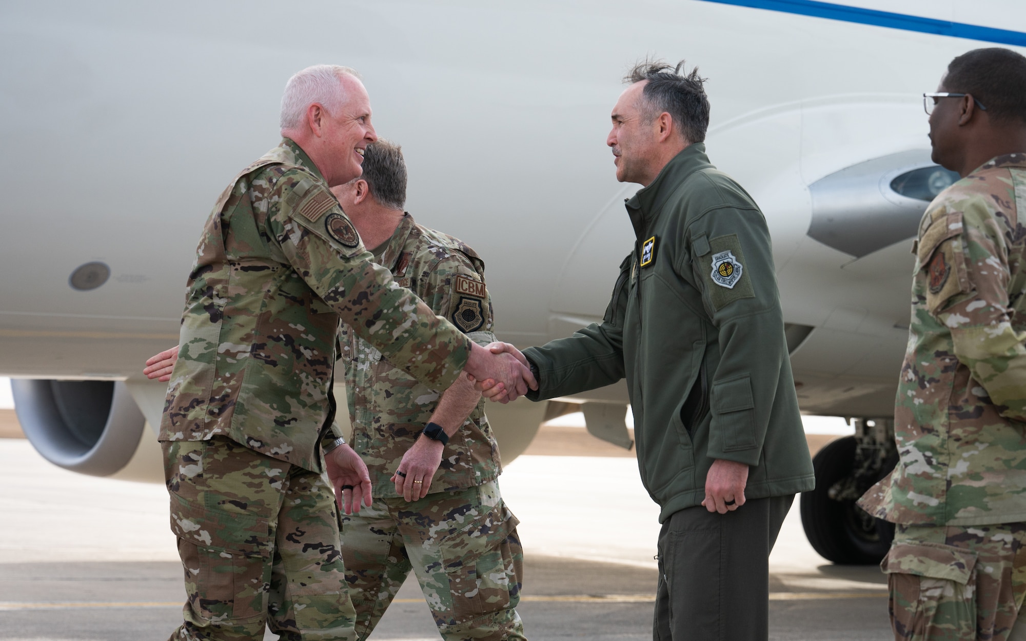 U.S. Air Force Gen. Dale R. White shakes hands with U.S. Air Force Col. Jesse Lamarand.