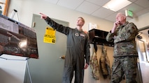 U.S. Air Force Gen. Dale R. White is briefed by U.S. Air Force Lt. Col Nicholas Gydesen.