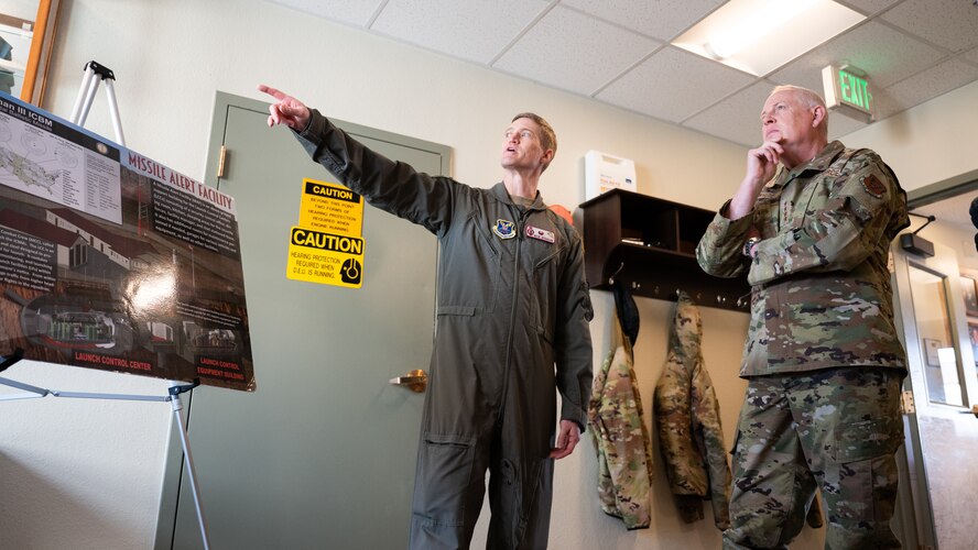 U.S. Air Force Gen. Dale R. White is briefed by U.S. Air Force Lt. Col Nicholas Gydesen.