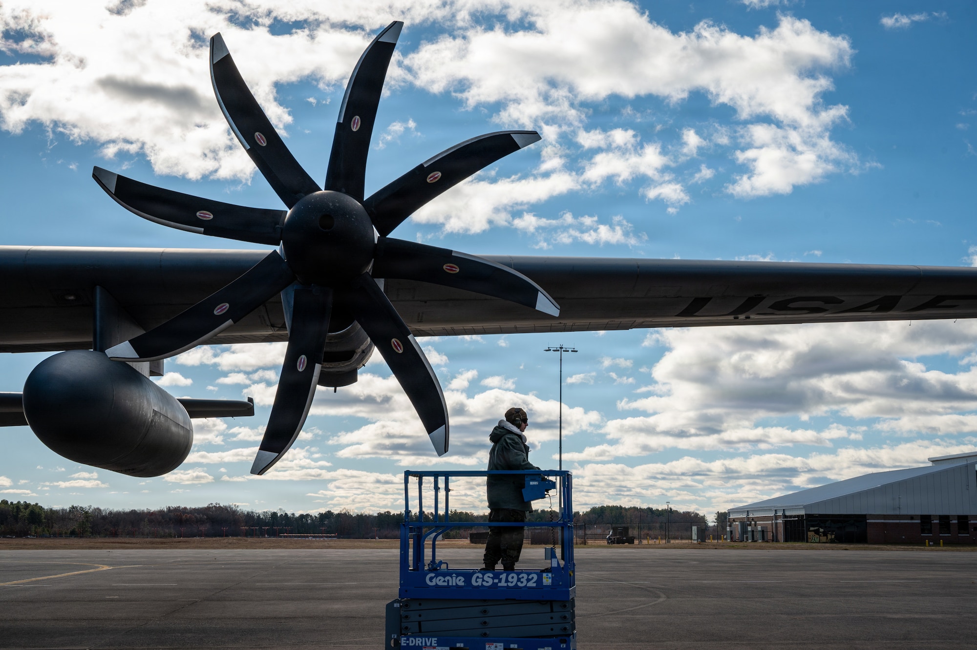 U.S. Staff Sgt. David Hatch, a propulsion technician in the 103d Maintenance Squadron Propulsion Shop, finishes work on a C-130 that has the NP2000 propeller modification on Nov. 18, 2025, East Granby, Conn. Hatch, along with other maintainers and flight operators, worked extensively to make this conversion happen in time for a fall deployment package of over one hundred airmen to the Horn of Africa. (U.S. Air National Guard photo by Captain Jen Kaprielian)