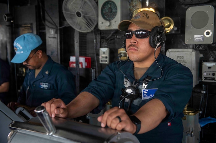 Seaman Enrique Vasquez stands lee helmsman watch aboard U.S. 7th Fleet flagship USS Blue Ridge (LCC 19) as the ship departs Manila, Philippines following a scheduled port visit, March 20, 2026.