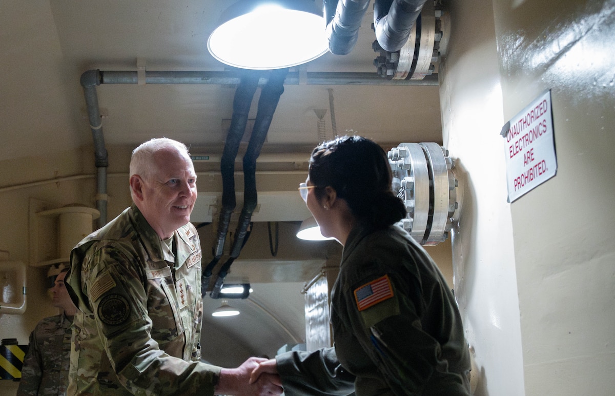 U.S. Air Force Gen. Dale R. White shakes hands with an Airman.