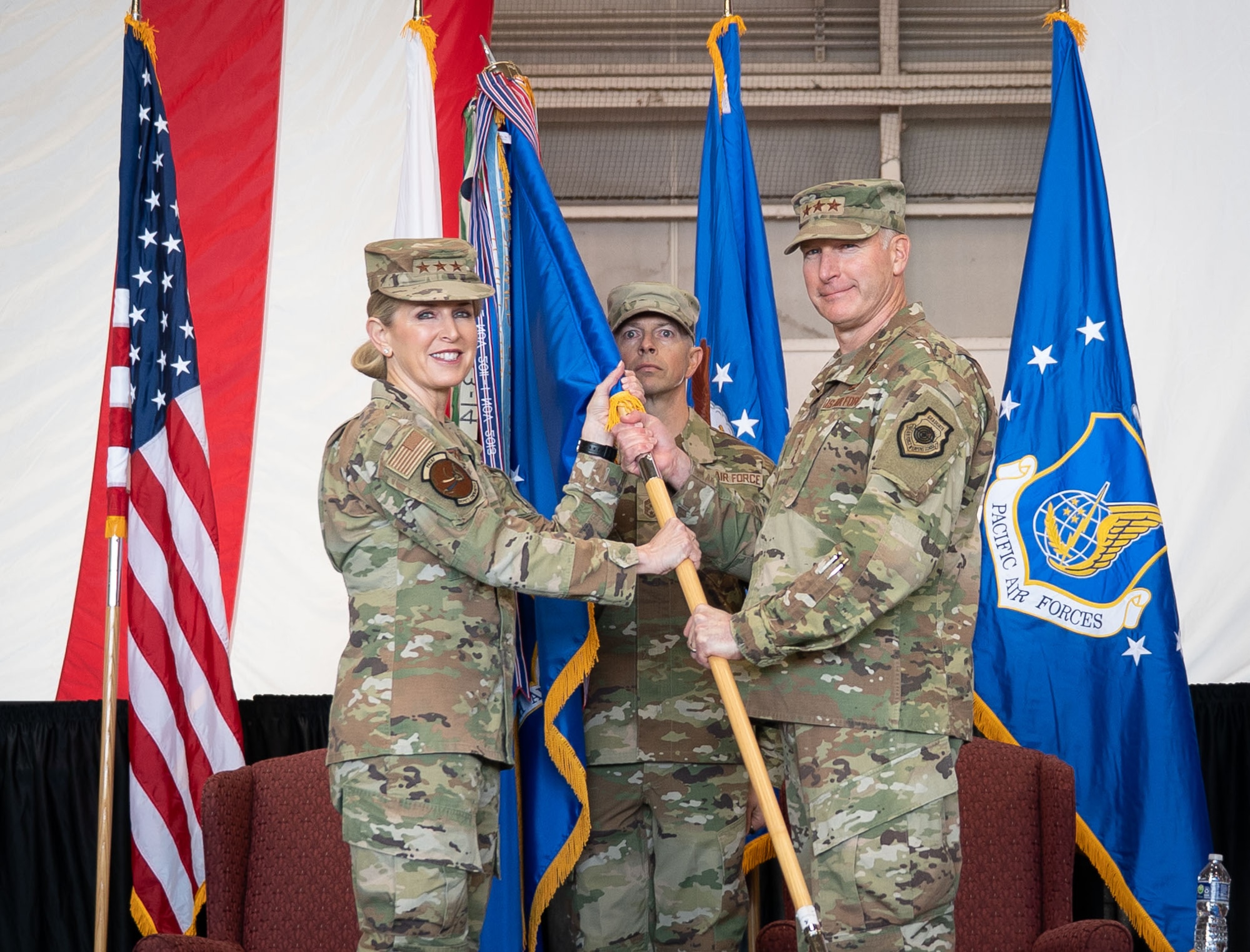U.S. Air Force Lt. Gen. Stephen Jost, U.S. Forces Japan commander and outgoing 5th Air Force commander, relinquishes the guidon to Lt. Gen. Laura Lenderman, Pacific Air Forces deputy commander, during the 5AF change of command ceremony at Yokota Air Base, Japan, March 24, 2026. The separation of 5AF will strengthen the command-and-control framework to enable seamless coordination of operations and capabilities, allowing for greater interoperability between U.S. and Japanese forces. (U.S. Air Force photo by Airman 1st Class Kayla Karelas)