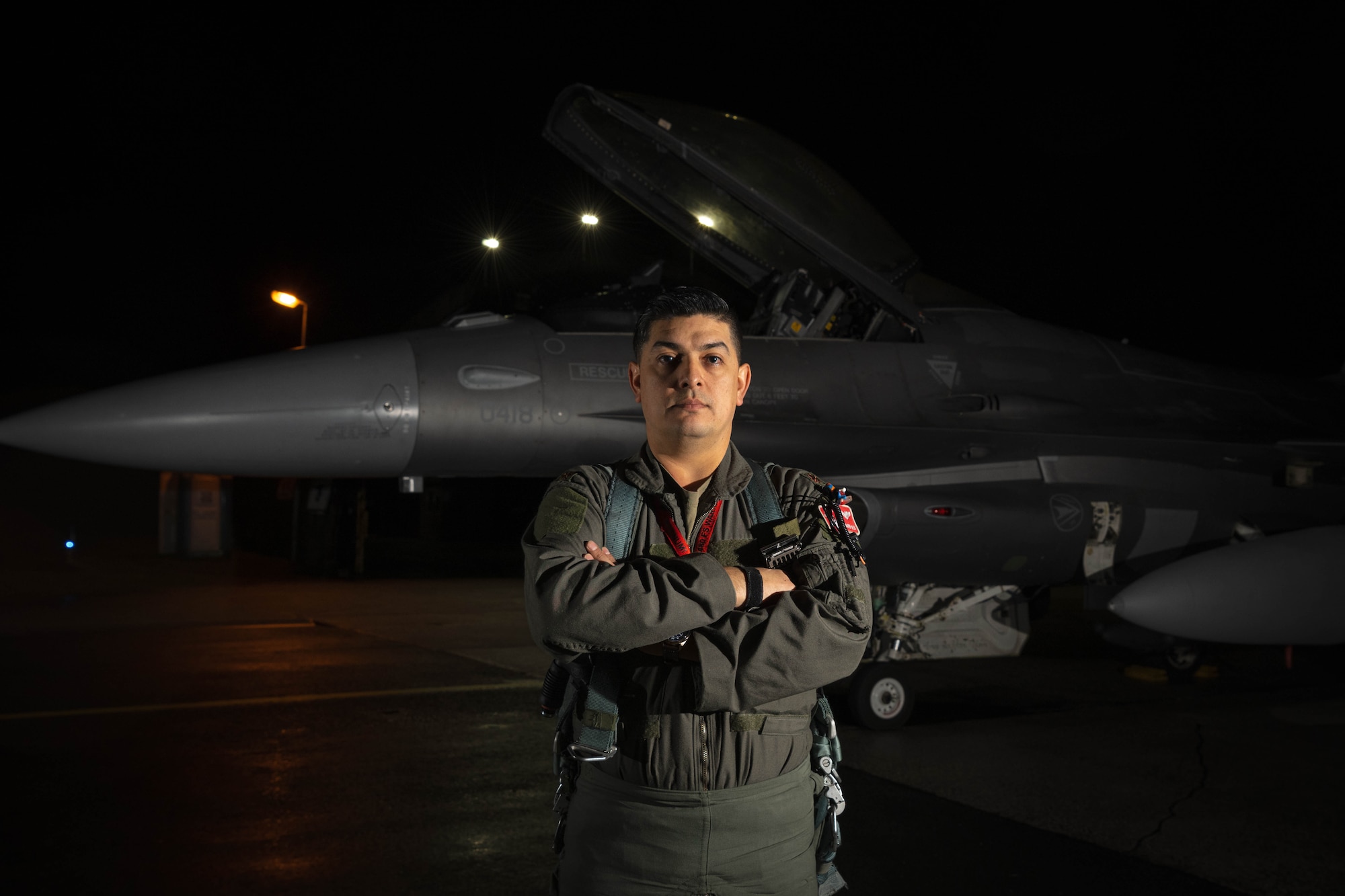 U.S. Air Force Maj. Michael Blea, 480th Fighter Squadron F-16 Fighting Falcon pilot, poses for a photo in front of a fighter jet at Spangdahlem Air Base, Germany, Dec. 10, 2025.