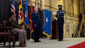 Maryland Air National Guard Col. Joed Carbonell-López, commander of the 175th Wing, stands during his flag unfurling and is promoted to brigadier general by Maryland Army National Guard Maj. Gen. Janeen Birckhead, adjutant general for Maryland, during a ceremony at Warfield Air National Guard Base at Martin State Airport, Maryland, March 22, 2026. In his role as wing commander, Carbonell-López oversees more than 1,400 personnel across three operations groups, one mission support group, one medical group, and one civil engineering element. (U.S. Air National Guard photo by Staff Sgt. Alexandra Huettner)