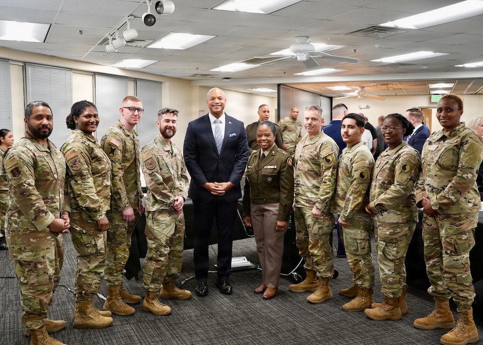 Maryland Gov. Wes Moore and Maryland Army National Guard Maj. Gen. Janeen L. Birckhead, adjutant general of Maryland, pose with Maryland National Guard's members of the Maryland Cybersecurity Task Force during a critical infrastructure interagency meeting at the Maryland Department of Information Technology in Crownsville, Maryland, March 9, 2026. The engagement was designed to build on the success of Maryland’s first state-led critical infrastructure cyber resilience workshop held in August 2025, which focused on the water and wastewater sector and convened more than 200 cybersecurity and infrastructure experts to improve collective cyber defense across government and industry. (U.S. Air National Guard Photo by Maj. Benjamin Hughes)