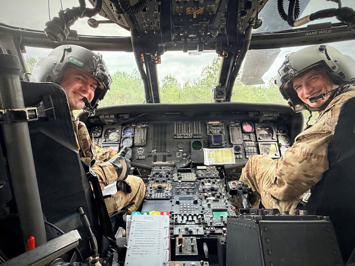 Georgia Army National Guard pilots Warrant Officer Austin Scales and Chief Warrant Officer 2 Ryan Jones from the Marietta-based 78th Aviation Troop Command pose in the cock pit of a UH-60L Black Hawk helicopter.