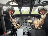 Georgia Army National Guard pilots Warrant Officer Austin Scales and Chief Warrant Officer 2 Ryan Jones from the Marietta-based 78th Aviation Troop Command pose in the cock pit of a UH-60L Black Hawk helicopter.