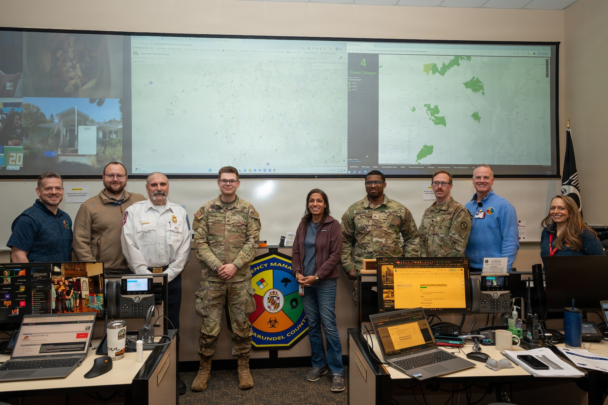 Emergency Operations Center staff pose with Maryland Army National Guard Soldiers in Anne Arundel County, Maryland, January 26, 2026. At the direction of Governor Wes Moore, approximately 200 personnel of the Maryland National Guard activated to support civil authorities with specialized vehicles across the state to ensure rapid response capabilities for communities that may require assistance during inclement weather conditions. (U.S. Army National Guard photo by Staff Sgt. Tom Lamb, photo edited for color and clarity)