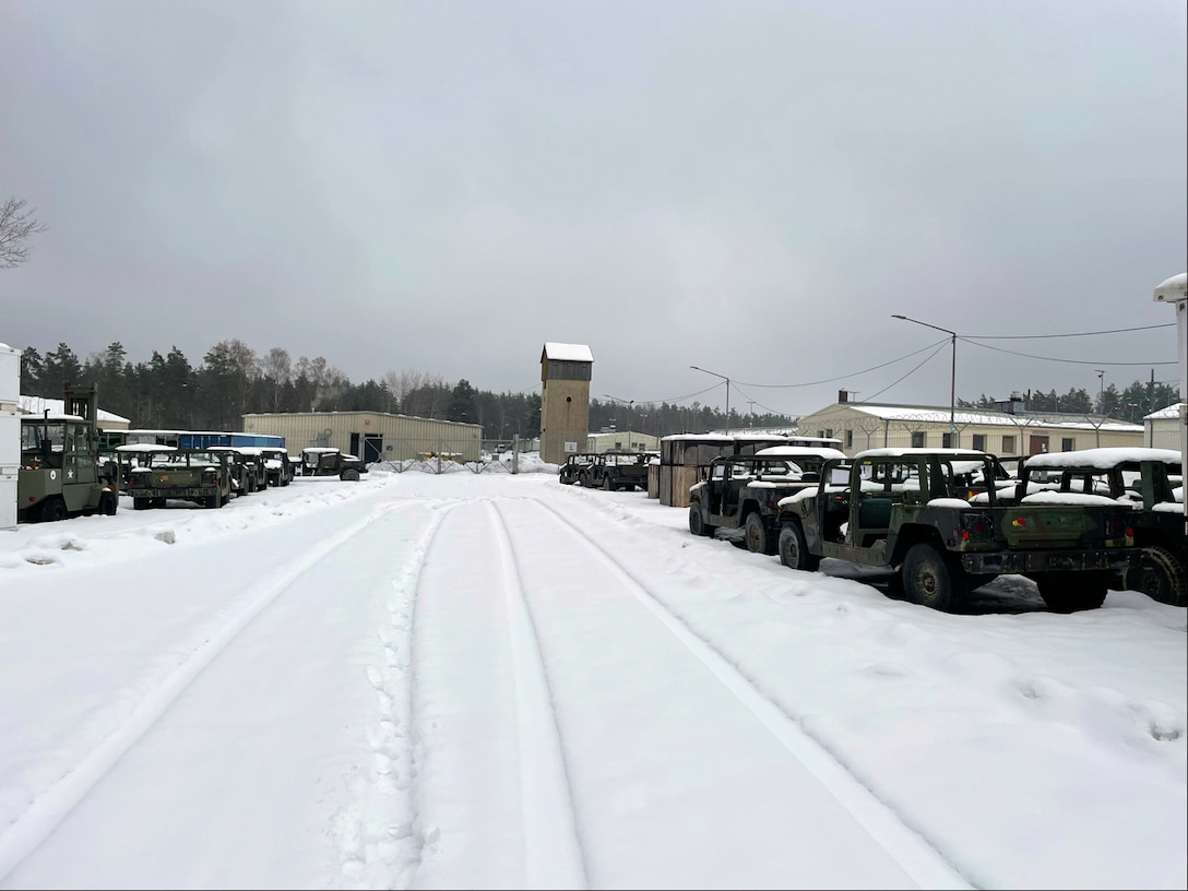 Older Humvees sitting outside in the snow