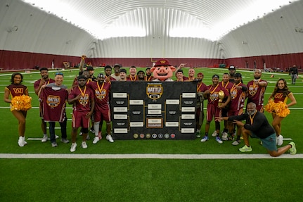 Team members representing Joint Base Andrews celebrate after winning the first Battle of the Bases flag football championship.