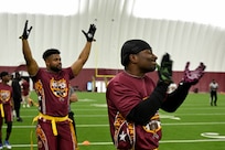 Team members representing Joint Base Andrews celebrate after scoring a touchdown at the Battle of the Bases flag football tournament.