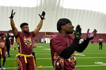 Team members representing Joint Base Andrews celebrate after scoring a touchdown at the Battle of the Bases flag football tournament.