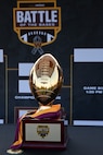 The Battle of the Bases flag football tournament trophy is displayed in front of the tournament bracket.