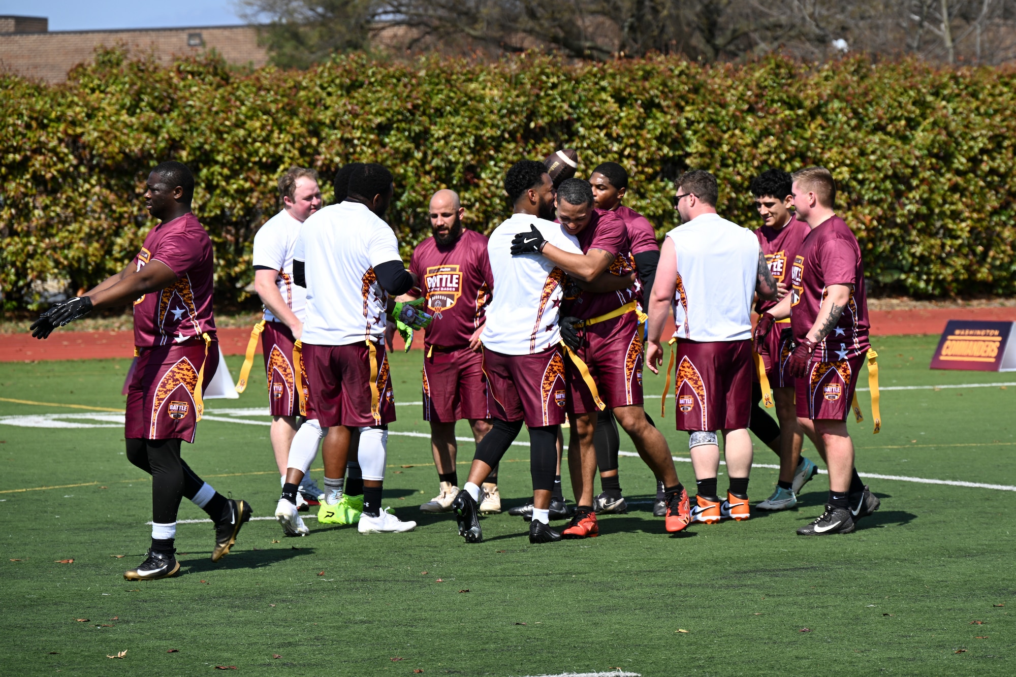Participants from Joint Base Myer-Henderson Hall and Naval Support Facility Indian Head shake hands after a game at the Battle of the Bases flag football tournament.