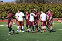 Participants from Joint Base Myer-Henderson Hall and Naval Support Facility Indian Head shake hands after a game at the Battle of the Bases flag football tournament.