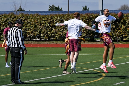 Two people celebrate after a touchdown at the Battle of the Bases flag football tournament at Joint Base Anacostia-Bolling, Washington, D.C., March 21, 2026.