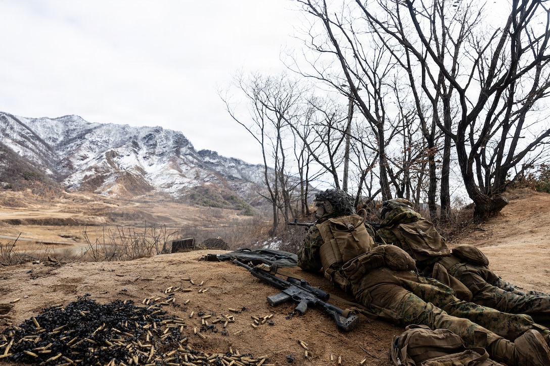 U.S. Marine Corps Cpl. Elias Vasquez, left, and Lance Cpl. Ezequiel Soto, both machine gunners with 12th Littoral Combat Team, 12th Marine Littoral Regiment, 3rd Marine Division, fire an M240B machine gun during a Combined Arms Live-Fire Exercise at Rodriguez Live-Fire Complex, Republic of Korea, March 3, 2026. 12th LCT Marines executed a company-level CALFEX, integrating organic and supporting fires, maneuver elements, and reconnaissance capabilities to conduct a coordinated assault on a designated objective. The range strengthened the unit’s ability to synchronize fires and movement in a dynamic training environment while enhancing combat effectiveness and overall readiness. Vasquez is a native of Texas and Soto is a native of Illinois. (U.S. Marine Corps photo by Cpl. Rodney Frye)
