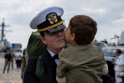 NAVAL STATION NORFOLK, Va. (March 23, 2026) Lt. Cmdr. Jessica Fonseca, a Sailor assigned to the Ticonderoga-class guided-missile cruiser USS Gettysburg (CG 64), embraces a family member following the ship's return to Naval Station Norfolk, March 23, after five months supporting U.S. Southern Command missions. Gettysburg is a multi-mission guided-missile cruiser capable of air warfare, undersea warfare, naval surface fire support and surface warfare, supporting carrier battle groups, amphibious forces or operating independently and as flagships of surface action groups. (U.S. Navy photo by Mass Communication Specialist 1st Class Anderson W. Branch)