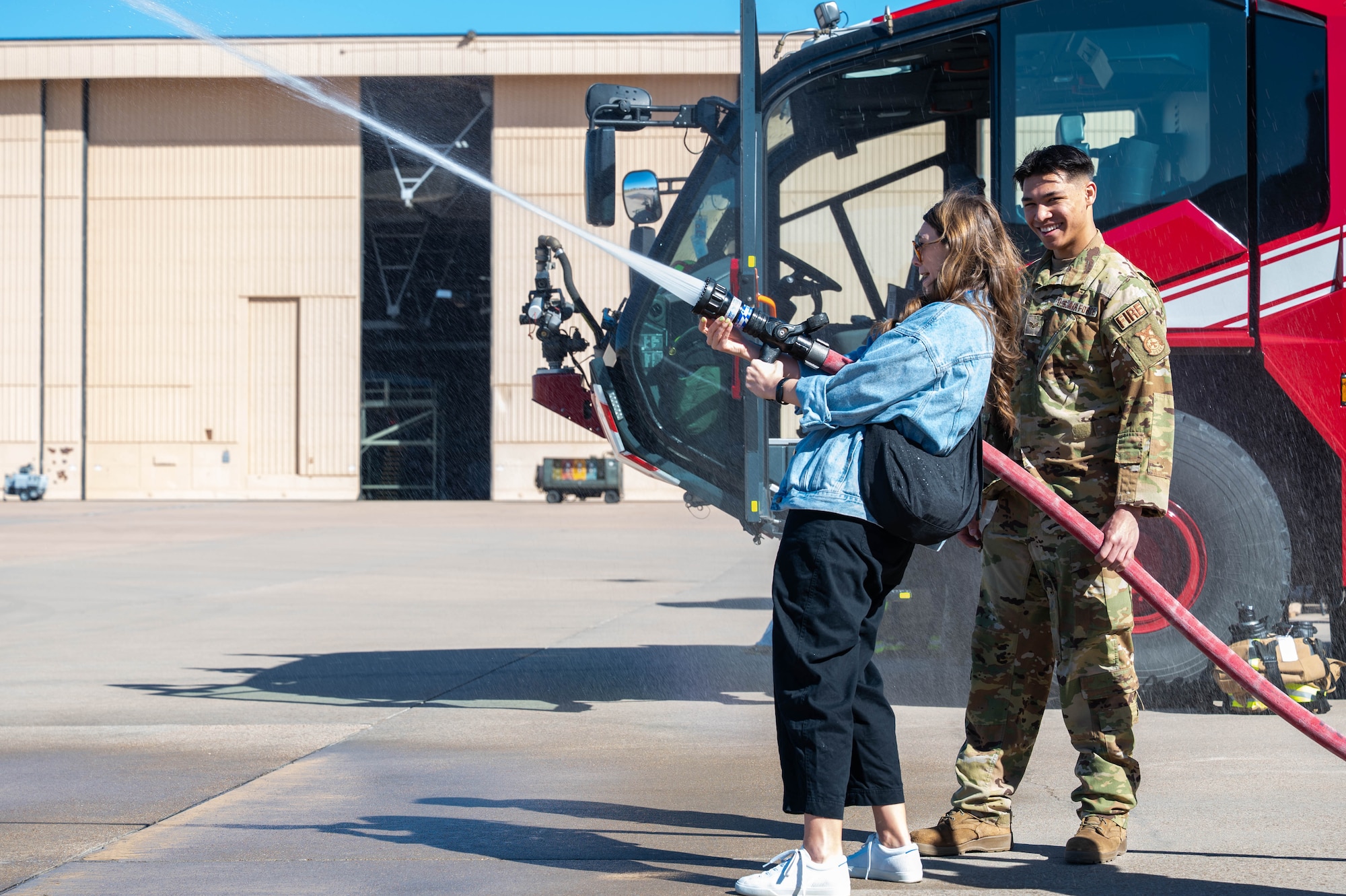 A member of the Leadership Abilene Class of 2026 receives hands-on instruction on firefighting equipment from a 7th Civil Engineer Squadron Airman at Dyess Air Force Base, Texas, March 19, 2026. The demonstration provided insight into the tools, techniques and procedures that are used to respond to emergencies. (U.S. Air Force photo by Airman 1st Class William Neal)