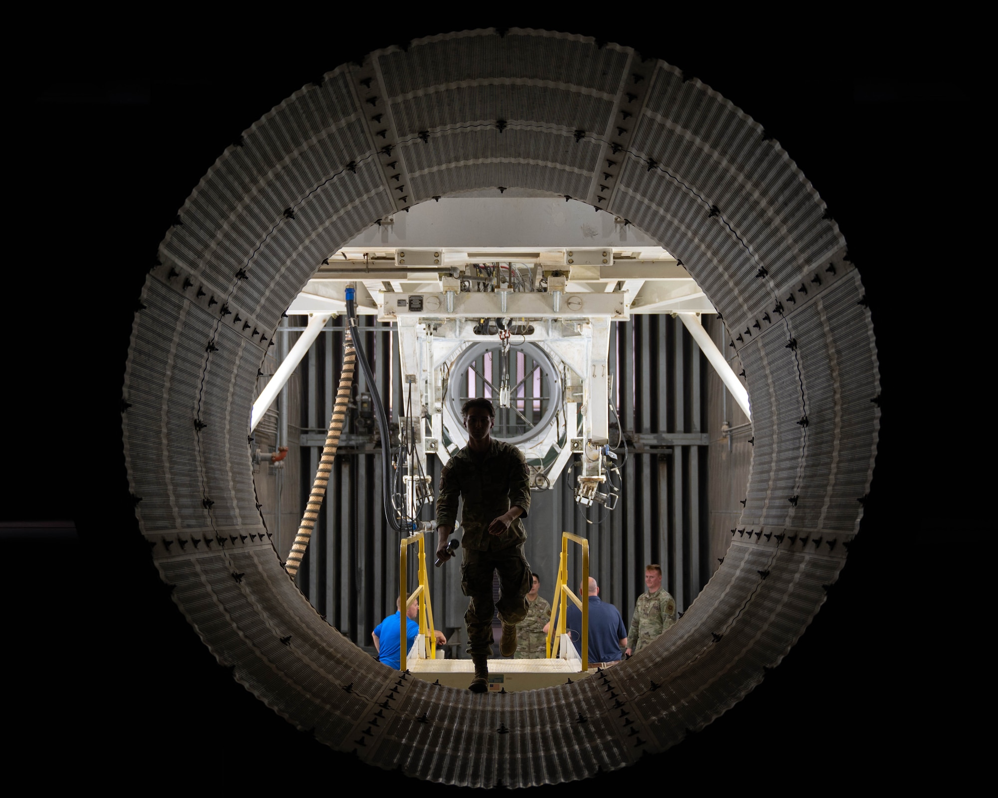 U.S. Air Force Staff Sgt. Kyle Fiske, 7th Component Maintenance Squadron test cell craftsman, walks through a B-1B Lancer engine test cell bay at Dyess Air Force Base, Texas, March 19, 2026. During the tour, members of the Leadership Abilene Class of 2026 learned how engine testing supports overall fleet health and aircraft reliability. (U.S. Air Force photo by Airman 1st Class William Neal)