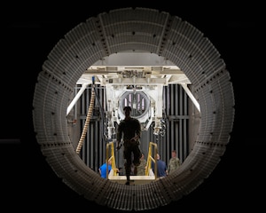 U.S. Air Force Staff Sgt. Kyle Fiske, 7th Component Maintenance Squadron test cell craftsman, walks through a B-1B Lancer engine test cell bay at Dyess Air Force Base, Texas, March 19, 2026. During the tour, members of the Leadership Abilene Class of 2026 learned how engine testing supports overall fleet health and aircraft reliability. (U.S. Air Force photo by Airman 1st Class William Neal)