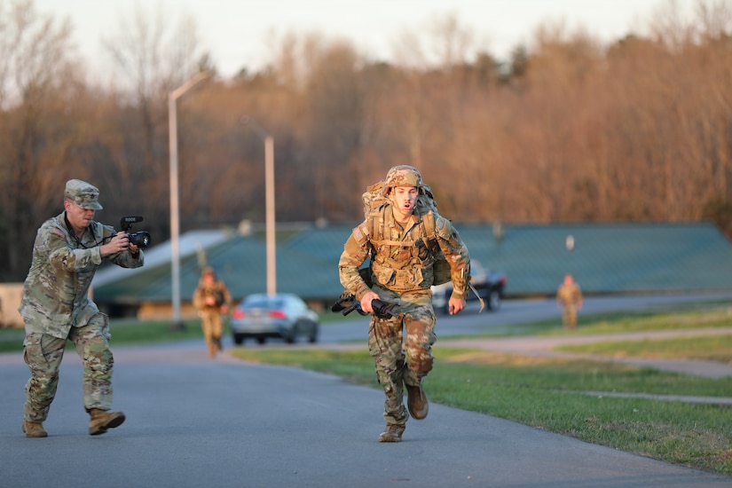 Spc. Caleb Green, Headquarters and Headquarters Battery, 138th Operational Fires Command, rushes toward the finish line of the ruck march at Wendel H. Ford Regional Training Center during the 2026 Best Warrior Competition March 22, 2026.