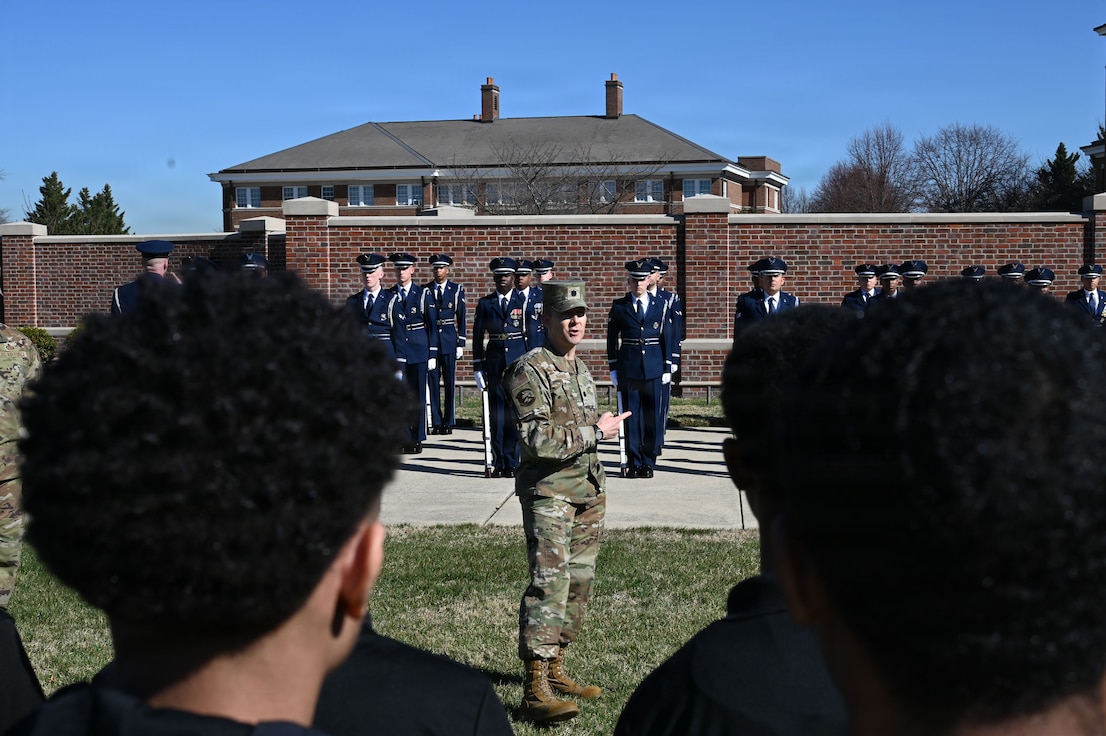 U.S. Air Force Lt. Col. Brandon Alford, commander of the U.S. Air Force Honor Guard, addresses Junior Reserve Officer Training Corps cadets during a tour of Joint Base Anacostia-Bolling, Washington, D.C., March 9, 2026. Alford explained the Honor Guard’s mission of connecting the American people to the Air Force and U.S. Space Force. (U.S. Air Force photo by Airman 1st Class Brandon Thomas)