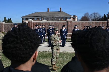 U.S. Air Force Lt. Col. Brandon Alford, commander of the U.S. Air Force Honor Guard, addresses Junior Reserve Officer Training Corps cadets during a tour of Joint Base Anacostia-Bolling, Washington, D.C., March 9, 2026. Alford explained the Honor Guard’s mission of connecting the American people to the Air Force and U.S. Space Force. (U.S. Air Force photo by Airman 1st Class Brandon Thomas)