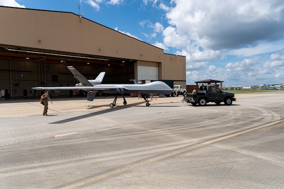 U.S. Airmen with the 116th Maintenance Group, 116th Air Control Wing, and 119th Wing, move a MQ-9 Reaper to its new location at Robins Air Force Base, Georgia, July 12, 2025. The 116th MXG consists of highly trained maintainers poised to conduct Remotely Piloted Aircraft Integration through the development and testing of legacy and next generation sensors and technology on a variety of RPAs. (U.S. Air National Guard photo by Master Sgt. Jeff Rice)