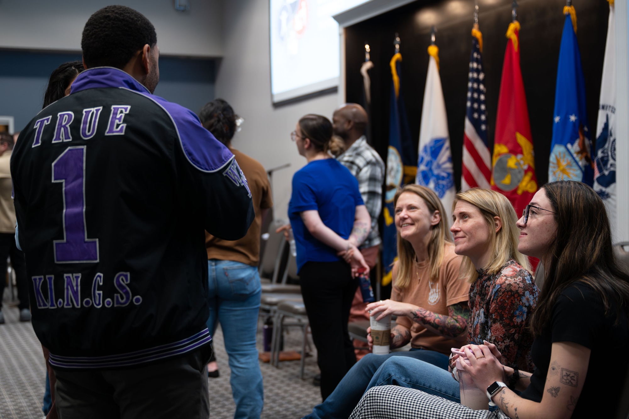 Wingman Guardian Connect course participants discuss among themselves before the next activity.